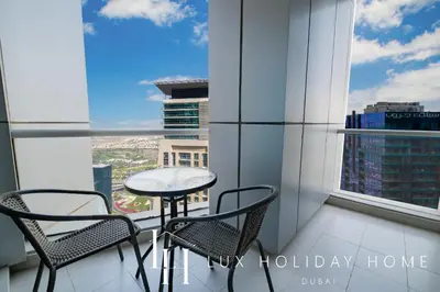 a table and chairs on a balcony with a view at LUX The Dubai Marina View Suite 2 in Dubai