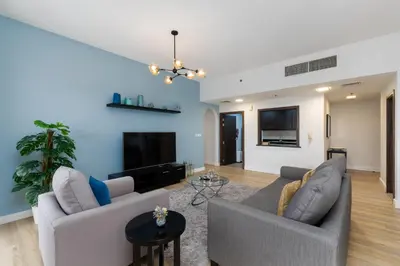 a living room with two couches and a tv at Shams 1, Jumeirah Beach Residence - Mint Stay in Dubai
