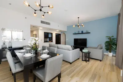a dining room and living room with a table and chairs at Shams 1, Jumeirah Beach Residence - Mint Stay in Dubai