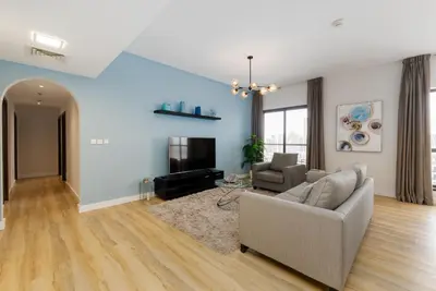 a living room with a couch and a tv at Shams 1, Jumeirah Beach Residence - Mint Stay in Dubai