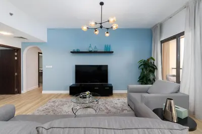 a living room with blue walls and a couch at Shams 1, Jumeirah Beach Residence - Mint Stay in Dubai