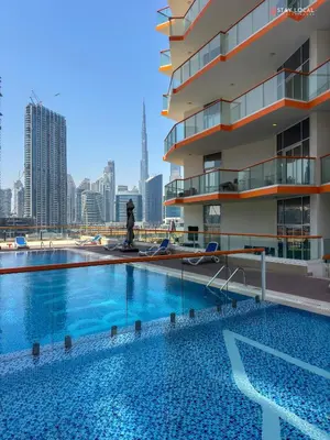 a large swimming pool in front of a building at Urban Living with Balcony, Pool, and Quick Access to Burj Khalifa in Dubai
