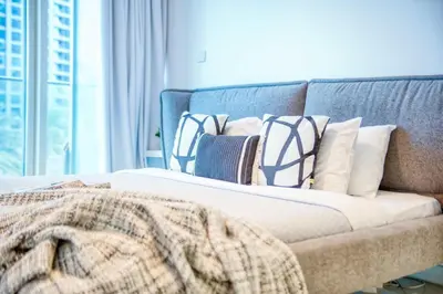 a bed with a blanket on top of it at The Smart Concierge - Damac Heights in Dubai