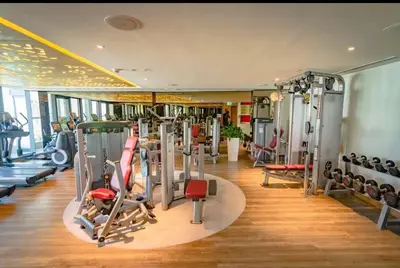 a gym with several treadmills and machines in a room at Moderne 1BR apartment overlooking city in Dubai