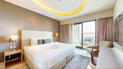 a bedroom with a large bed and a large window at Moderne 1BR apartment overlooking city in Dubai