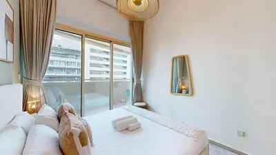 a living room with a couch and a large window at Vacationer I Premium 1 Bed I Dubai Marina Living & Metro Nearby I Dream Tower in Dubai
