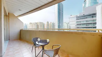 a balcony with two chairs and a table with a view at Vacationer I Premium 1 Bed I Dubai Marina Living & Metro Nearby I Dream Tower in Dubai