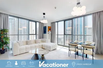 a living room with a white couch and a table at Creek Residences - One Bedroom with Creek View in Dubai