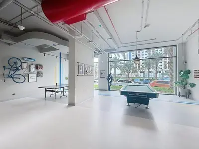 a room with a ping pong table in a building at UNA Tower - Peaceful One Bedroom in Townsquare in Dubai