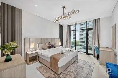 a bedroom with a large bed and a large window at Seven Palm Residences - Private Beach Access, Infinity Pool with Sea View in Dubai
