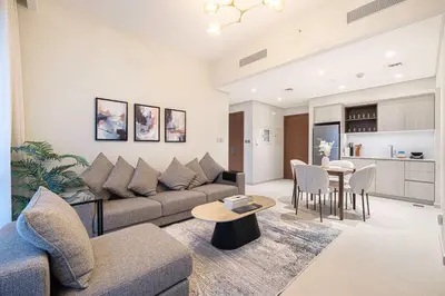 a living room with a couch and a table at Stylish 1BR City View at Vida Creek Beach in Dubai