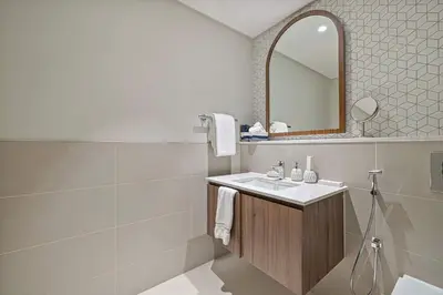 a bathroom with a sink and a mirror at Stylish 1BR City View at Vida Creek Beach in Dubai
