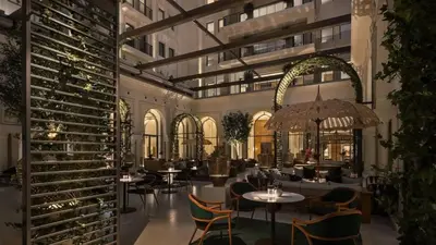 a restaurant with tables and chairs and wine racks at Stylish 1BR City View at Vida Creek Beach in Dubai