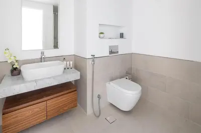 a white bathroom with a sink and a toilet at Frank Porter - Lamtara 3, MJL in Dubai