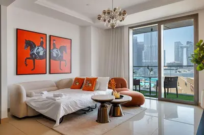 a living room with a couch and a table at Trendy 1BR Dubai Dream with full BurjViews Above Dubai Mall in Dubai