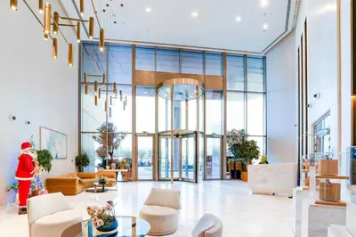 a lobby of a building with a woman in a santa outfit at Trendy 1BR Dubai Dream with full BurjViews Above Dubai Mall in Dubai
