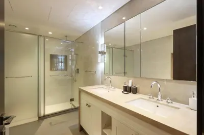 a bathroom with two sinks and a shower at 2BR with Iconic Burj and Dubai Fountain Views in Dubai