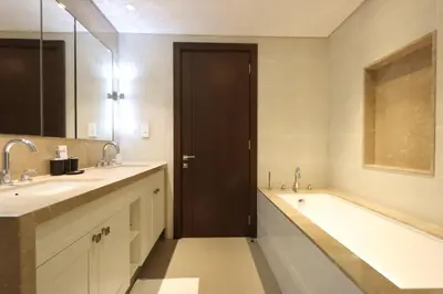 a bathroom with two sinks and a bath tub at 2BR with Iconic Burj and Dubai Fountain Views in Dubai