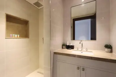 a bathroom with a sink and a mirror at 2BR with Iconic Burj and Dubai Fountain Views in Dubai
