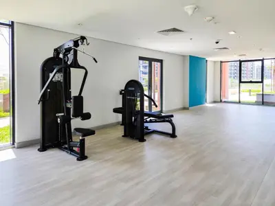 a gym with two tread machines in a room at Modern Elegance in a Cosy Retreat with Balcony - Azizi Riviera in Dubai