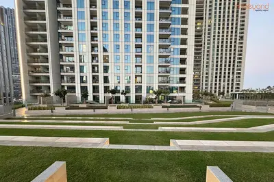 a park in front of a large building at Bnbeyond's Artistic Luxe Retreat with Burj Views in Dubai