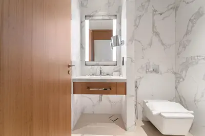 a bathroom with a toilet and a sink and a mirror at Address Residence Dubai Opera 34 by Luxstay Holiday Homes in Dubai