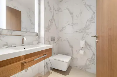 a white bathroom with a toilet and a sink at Address Residence Dubai Opera 34 by Luxstay Holiday Homes in Dubai