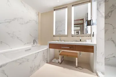 a bathroom with a tub and a sink and a mirror at Address Residence Dubai Opera 34 by Luxstay Holiday Homes in Dubai