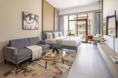 a living room with a couch and a bed at Frank Porter - Westwood Grande in Dubai