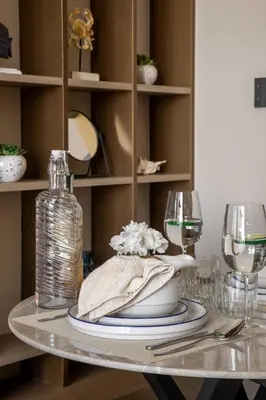 a table with two glasses and a bottle of wine at Frank Porter - Westwood Grande in Dubai