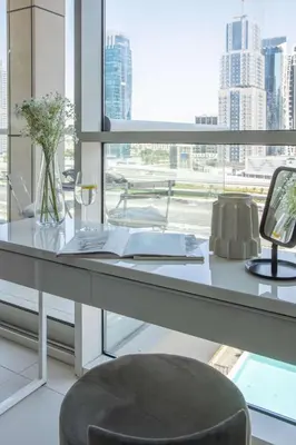 an office with a desk and a chair and a window at Frank Porter - West Avenue in Dubai