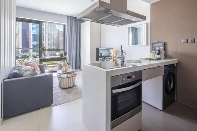 a kitchen with a sink and a stove top oven at Frank Porter - West Avenue in Dubai