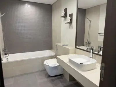 a bathroom with a sink and a tub and a toilet at Dubai Frame Views Steps from Metro & Sheikh Zayed Road in Dubai
