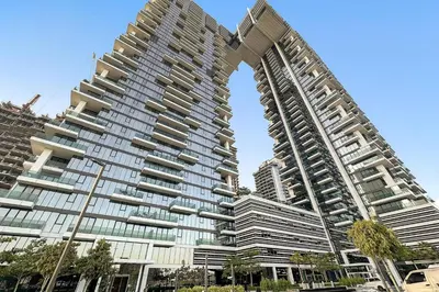 a large apartment building with a arch in front of it at Dubai Frame Views Steps from Metro & Sheikh Zayed Road in Dubai