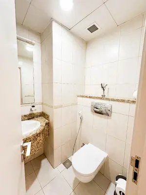 a bathroom with a toilet and a sink at Charming 1BR with Sea & City Views in Dubai