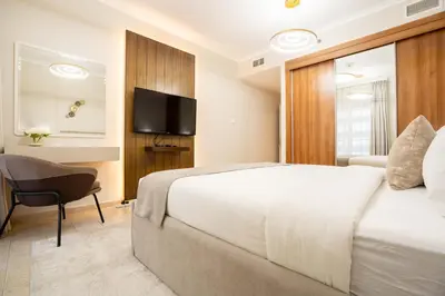 a bedroom with a bed and a desk and a television at Charming 1BR with Sea & City Views in Dubai