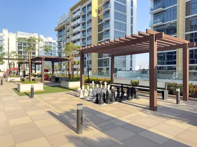a chess set in a park in a city at FIRST CLASS Studio Modern Vibes in Dubai in Dubai