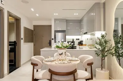 a kitchen and dining room with a table and chairs at Burj et Canal View Sunny Pool in Dubai