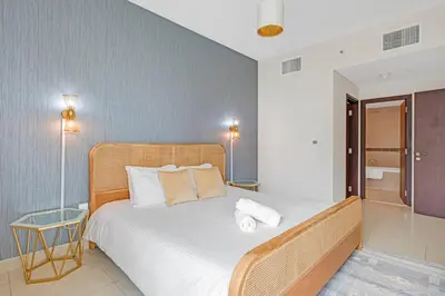 a bedroom with a bed with two towels on it at Bellavista - 1 Bedroom Apartment - 29 Boulevard in Dubai