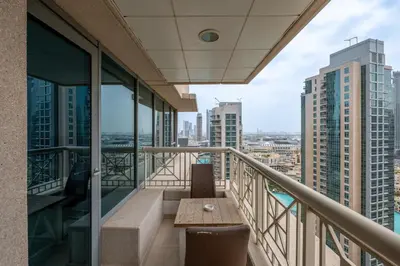 a balcony with a table and views of the city at Bellavista - 1 Bedroom Apartment - 29 Boulevard in Dubai