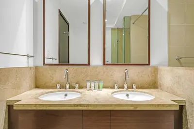 a bathroom with two sinks and two mirrors at Bellavista - 1 Bedroom Apartment - 29 Boulevard in Dubai