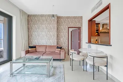 a living room with a couch and a table at Bellavista - 1 Bedroom Apartment - 29 Boulevard in Dubai