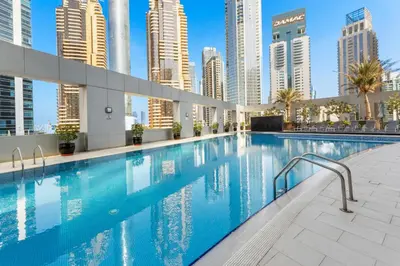 a swimming pool in a city with tall buildings at Modern 1BR JBR View No Car Needed! in Dubai