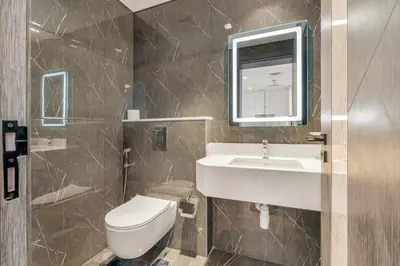 a bathroom with a sink and a toilet at Chic One-Bed Haven w Pool & Gym Heart of Dubai in Dubai