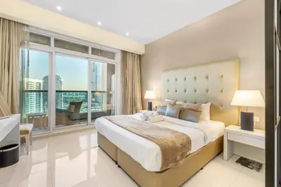 a bedroom with a large bed and a large window at Live the Dubai Dream Premium Flat in Business Bay in Dubai