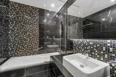 a bathroom with a sink and a shower and a tub at Live the Dubai Dream Premium Flat in Business Bay in Dubai
