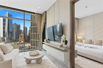 a bathroom with a tub and a large window at Modern 1Bedroom w Burj Khalifa view in Peninsula in Dubai
