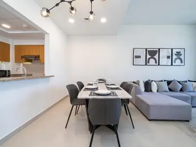 a living room with a table and a couch at Modern Downtown 2 Bed plus Maids with Full Burj View in Dubai