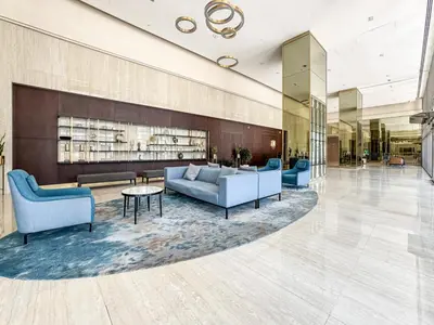 a lobby with couches and chairs and a fireplace at Modern Downtown 2 Bed plus Maids with Full Burj View in Dubai