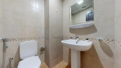 a bathroom with a toilet and a sink and a mirror at Royal Oceanic - Bright Two Bed on the 14th Floor in Dubai